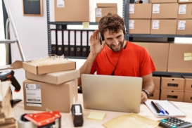 young-hispanic-call-center-agent-man-working-warehouse-smiling-with-hand-ear-listening-hearing-rumor-gossip-deafness-concept-100kb